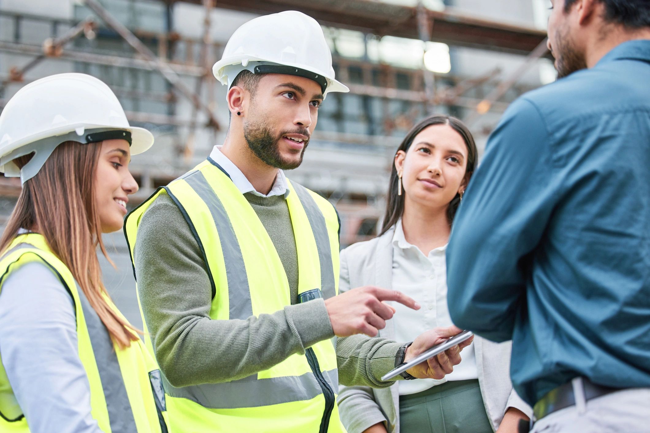 Construction workers discussing plans at a site.
