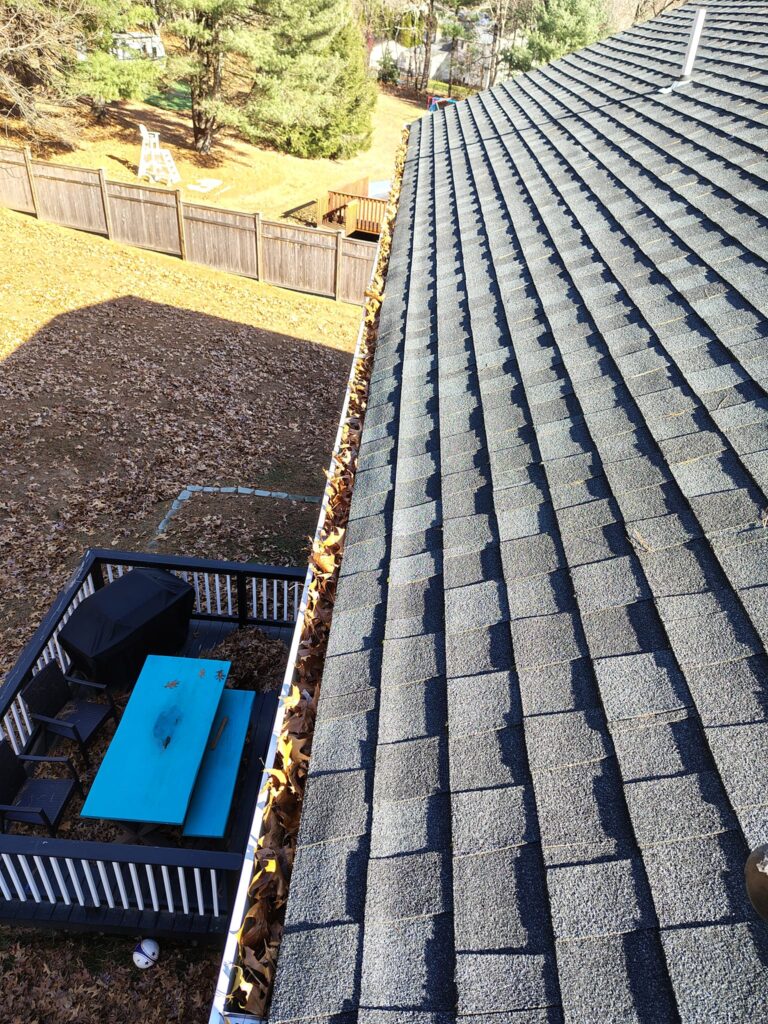 Roof with solar panels and a truck below.