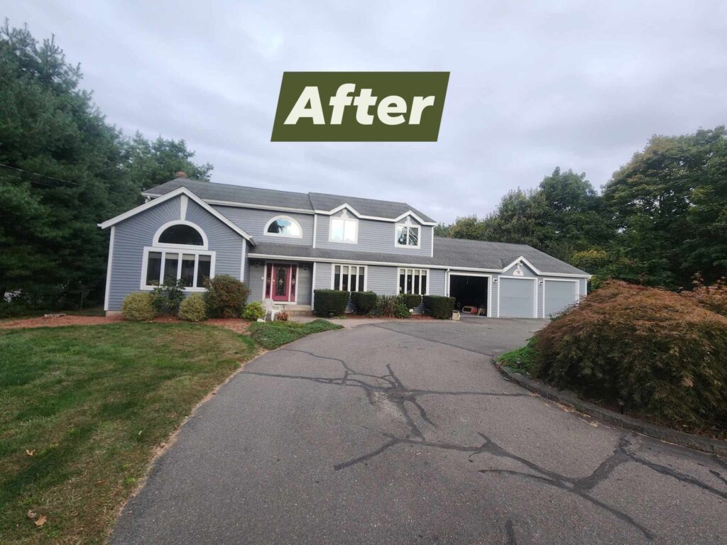 Renovated house with fresh landscaping and a clean driveway.