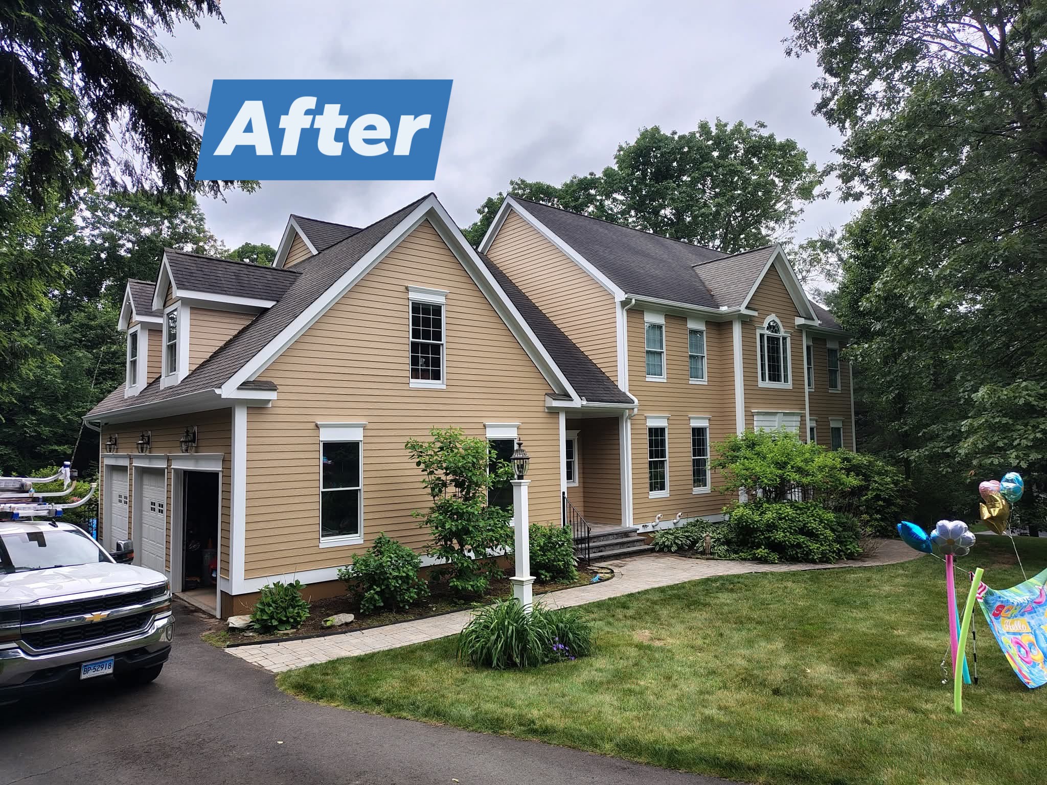 Renovated brick house exterior with fresh siding and clean landscaping.